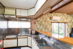 a kitchen with white cabinets and a sink at Long - Vacation STAY 56447v in Manazuru