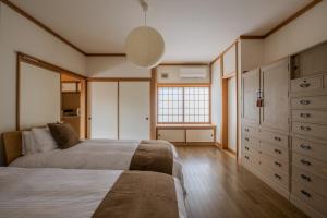 a bedroom with a bed and a window in it at Private Inn Kazu - Vacation STAY 56401v in Abuta