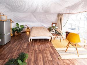 a bedroom with a bed in a tent at Kaamlanai Harbor - Vacation STAY 40317v in Nichinan