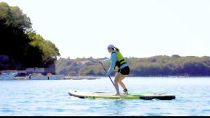 a woman on a paddle board in the water at UMILABO - Vacation STAY 64339v in Shima