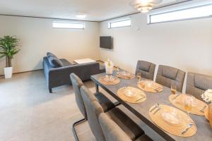 a dining room with a long table and chairs at Grandioso Okinawa Pool Villa 8 - Vacation STAY 51219v in Onna