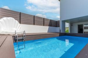 a swimming pool on the roof of a house at Grandioso Okinawa Pool Villa 8 - Vacation STAY 51219v in Onna
