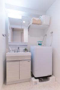 a bathroom with a sink and a mirror at WOM Condominium Tamatsukuri - Vacation STAY 64193v in Osaka
