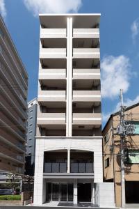 a white building with a cross on top of it at WOM Condominium Tamatsukuri - Vacation STAY 64193v in Osaka