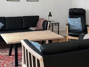 a living room with a couch and a table at 5 star holiday home in Nakskov in Nakskov