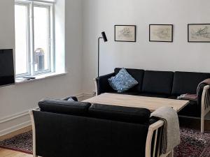 a living room with a couch and a table at 5 star holiday home in Nakskov in Nakskov