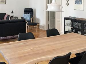 a living room with a wooden table and chairs at 5 star holiday home in Nakskov in Nakskov