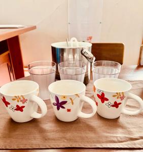 a table with four coffee mugs and glasses on it at Mori no hoshi - Vacation STAY 65135v in Kunigami