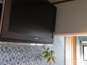 a flat screen tv hanging on a wall at Yadokari 852 - Vacation STAY 56348v in Manazuru