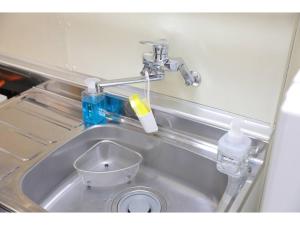 a kitchen sink with a faucet and a bottle of water at City Avenue Asahimachi - Vacation STAY 18053 in Sapporo +34 photos