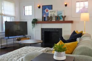 a living room with a couch and a fireplace at Boston Manor in Indianapolis