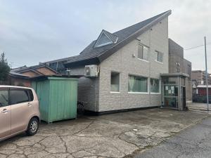 a van parked in front of a brick house at Takaoka - House - Vacation STAY 18350 in Takaoka