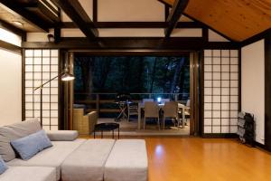 a living room with a couch and a table at Soubokuan - Vacation STAY 77265v in Sengokuhara