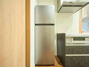 a stainless steel refrigerator in a kitchen at Chocotto Villa Maestro - Vacation STAY 73565v in Sumoto