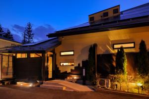 a home with a lit up facade at night at Kazekuru - Vacation STAY 18924 in Fujiyoshida