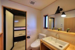 a bathroom with a toilet and a sink and a mirror at Kazekuru - Vacation STAY 18924 in Fujiyoshida +33 photos