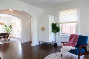 a living room with a blue chair and a window at Boston Manor in Indianapolis