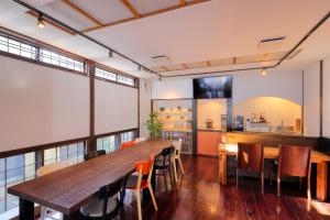 a dining room with a large wooden table and chairs at Kazekuru - Vacation STAY 18924 in Fujiyoshida