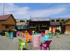 eine Gruppe bunter Stühle vor einem Gebäude in der Unterkunft SUNSEA COTTAGE - Vacation STAY 82156v in Tagawa
