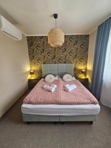 a bedroom with a bed with two towels on it at LUCAFIORI Hotel OBORY in Obory +3 photos