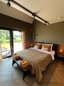 a bedroom with a large bed and a large window at Bed en breakfast Suite 8 in Langenboom