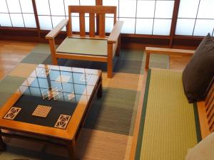 a living room with two chairs and a table at Hida Town House Grass - Vacation STAY 77084v in Takayama