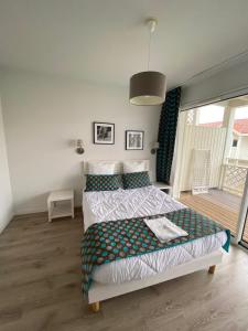 a bedroom with a bed and a balcony at Mimizan plage Balcon des pêcheurs in Mimizan-Plage +43 photos