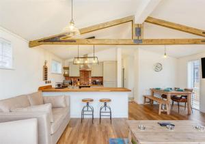 a living room with a couch and a table at Sanctuary Pathfinder Lodge in Fort Augustus