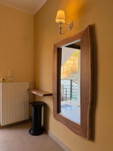 a mirror on the wall in a room at Filoxenia Harmony Retreat in Keratea