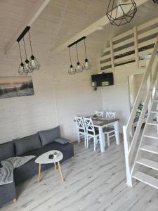 a living room with a couch and a table at Biały Sztorm in Rusinowo