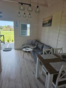 a living room with a couch and a table at Biały Sztorm in Rusinowo +21 photos