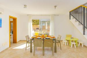 a dining room with a table and chairs at Villa Synera in Alcudia
