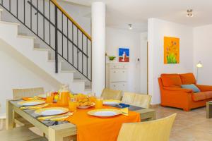 a dining room with a table with orange dishes on it at Villa Synera in Alcudia