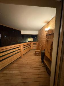 a balcony with a wooden floor and a wooden chair at Vars Livingstone in Vars