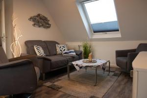 a living room with a couch and a table at Deichhöhe 7 HO 1 in Norddeich