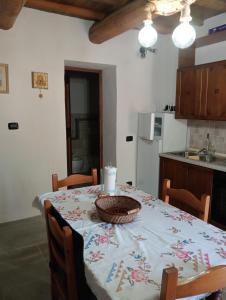 a kitchen with a table with a basket on it at La Guardia in Bivigliano