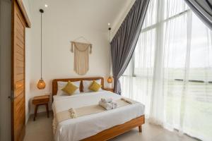 a bedroom with a bed with a teddy bear on it at Sunrise Bliss 15 Ricefield View Private Pool Villa By Bali Bliss Properties in Dalung +94 photos