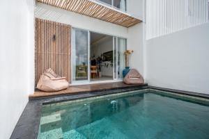 a swimming pool in front of a house at Sunrise Bliss 15 Ricefield View Private Pool Villa By Bali Bliss Properties in Dalung