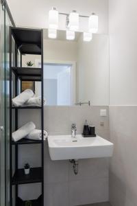 a bathroom with a sink and a mirror at Urban Hideaway Vienna in Vienna +20 photos