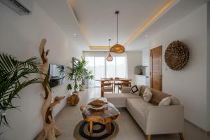 a living room with a couch and a table at Sunrise Bliss 15 Ricefield View Private Pool Villa By Bali Bliss Properties in Dalung