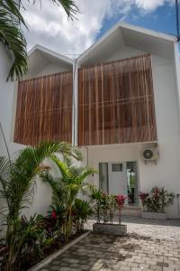 a house with a waterfall on the side of it at Sunrise Bliss 15 Ricefield View Private Pool Villa By Bali Bliss Properties in Dalung