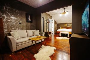 a living room with a couch and a bed at Pepin Stay in Topoľčany