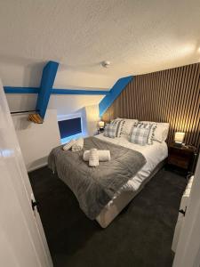 a bedroom with a large bed with two towels on it at The Mason arms in Camelford