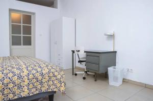 a bedroom with a bed and a desk and a table at Kaze - Bienvenue chez vous in Grimbergen