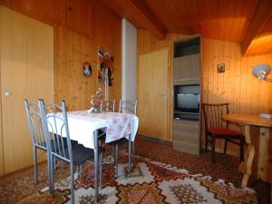 a dining room with a table and chairs and a television at Chalet in Wilderswil with Jungfrau Views in Wilderswil