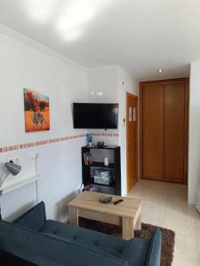 a living room with a blue couch and a table at Estudio Centro A Guarda in A Guarda