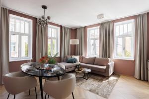 a living room with a table and a couch at Urban Hideaway Vienna in Vienna