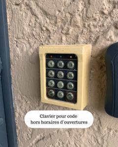 a remote control attached to a stone wall at Le Bassin Hôtel Restaurant in LʼIsle-sur-la-Sorgue
