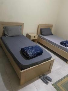 Dos camas individuales en una habitación con una litera. en ZIKE-D, a home to rent!, en Berat