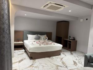 a hotel room with a bed with flowers on it at Chandi Haveli in Khed